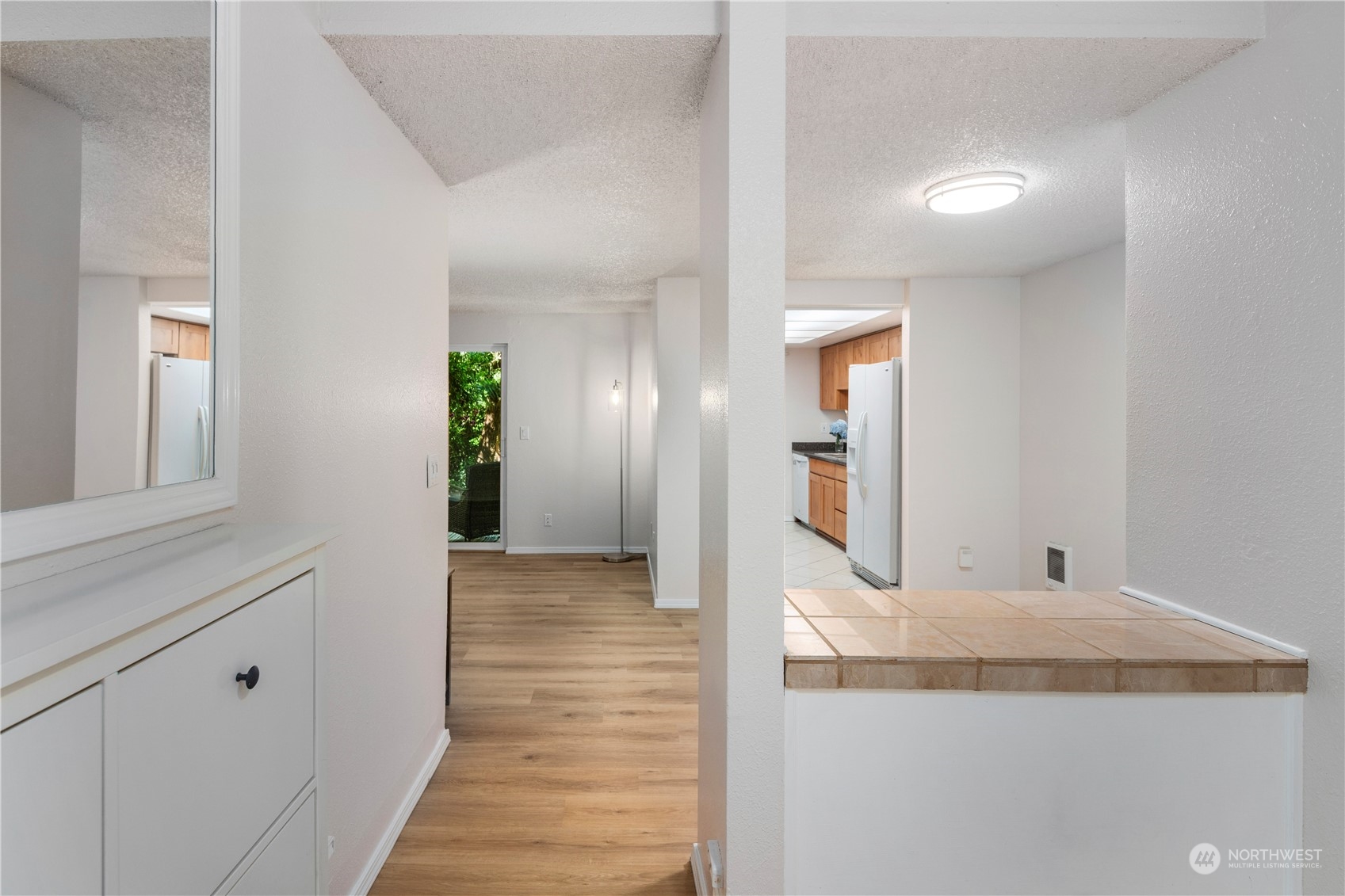 17522 151st Avenue Southeast, Unit 31 Renton, WA 98058 - Photo 20 of 37 a view of a hallway with wooden floor and cabinet