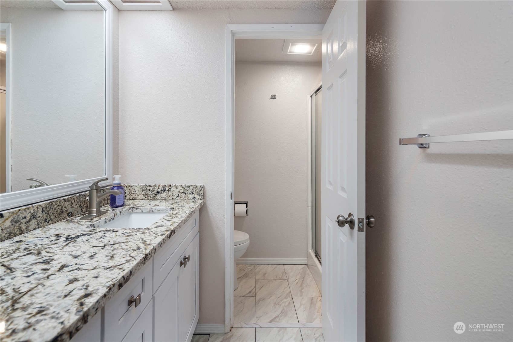 17522 151st Avenue Southeast, Unit 31 Renton, WA 98058 - Photo 25 of 37 a bathroom with a granite countertop sink and a mirror