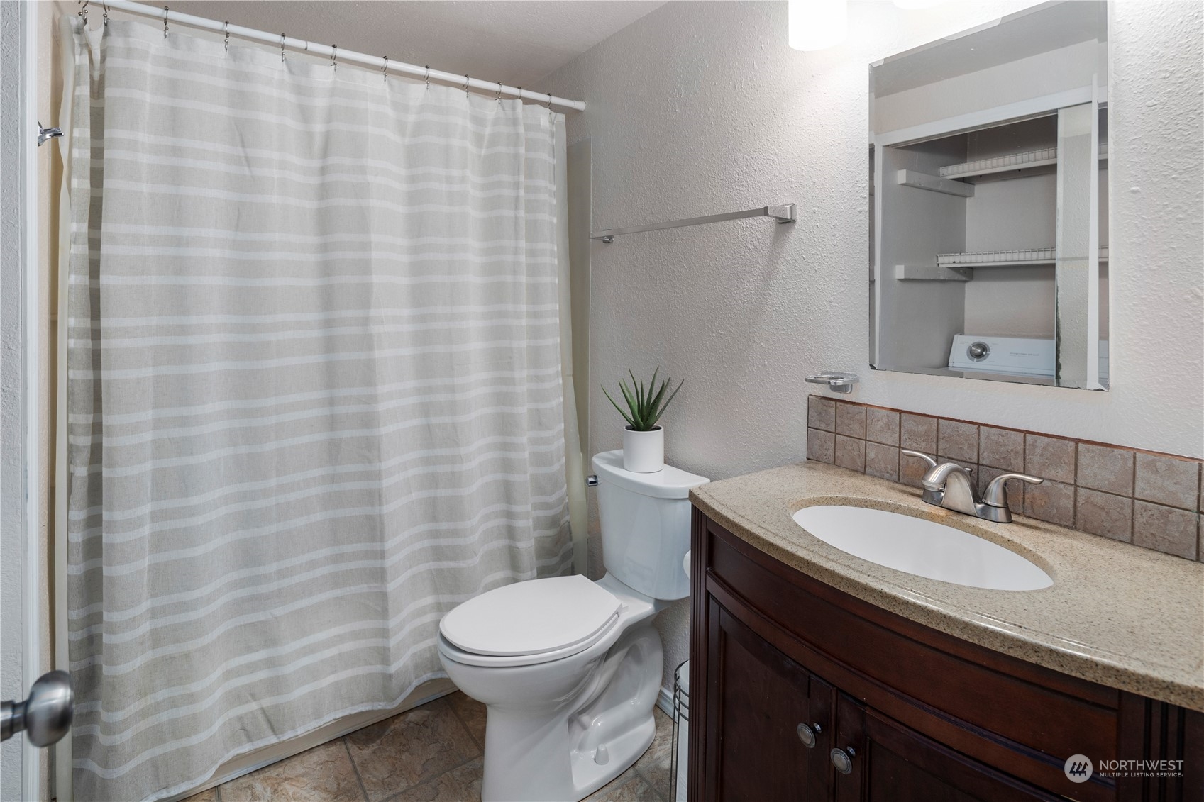 17522 151st Avenue Southeast, Unit 31 Renton, WA 98058 - Photo 29 of 37 a bathroom with a sink a toilet and shower curtain