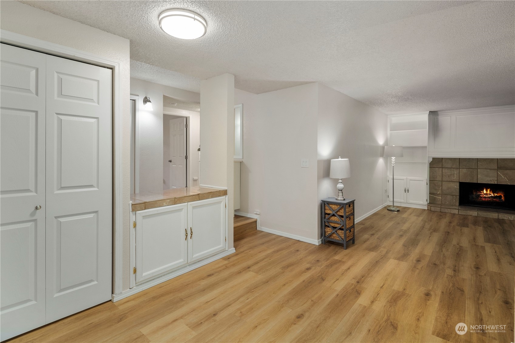 17522 151st Avenue Southeast, Unit 31 Renton, WA 98058 - Photo 6 of 37 a view of a livingroom with wooden floor and a fireplace
