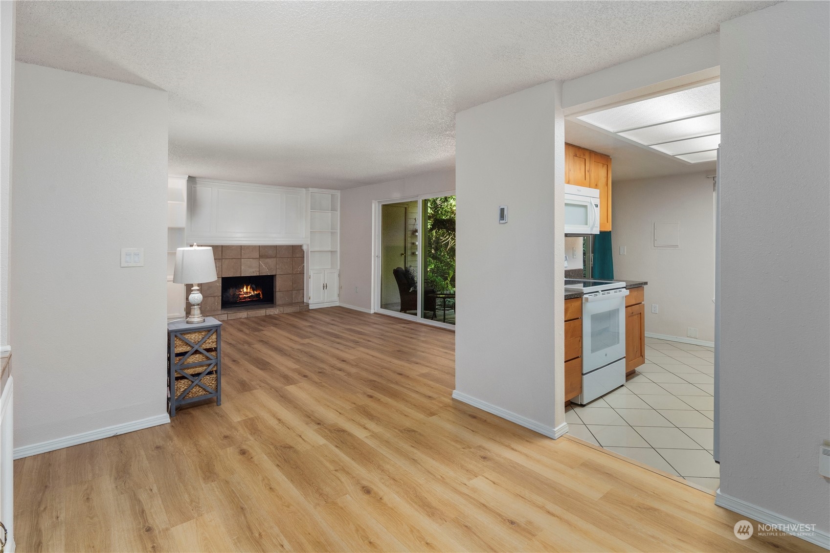 17522 151st Avenue Southeast, Unit 31 Renton, WA 98058 - Photo 7 of 37 an empty room with wooden floor a fireplace and windows