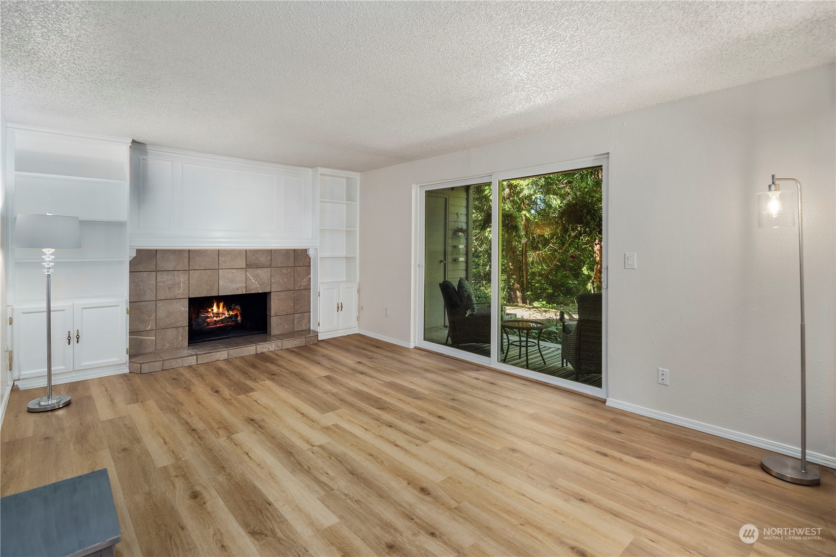 17522 151st Avenue Southeast, Unit 31 Renton, WA 98058 - Photo 8 of 37 a view of an empty room with wooden floor fireplace and a window