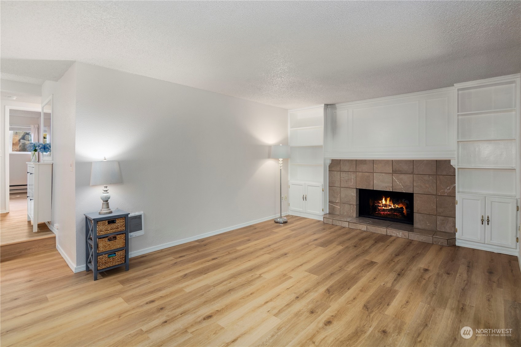 17522 151st Avenue Southeast, Unit 31 Renton, WA 98058 - Photo 9 of 37 a view of empty room with wooden floor and fireplace