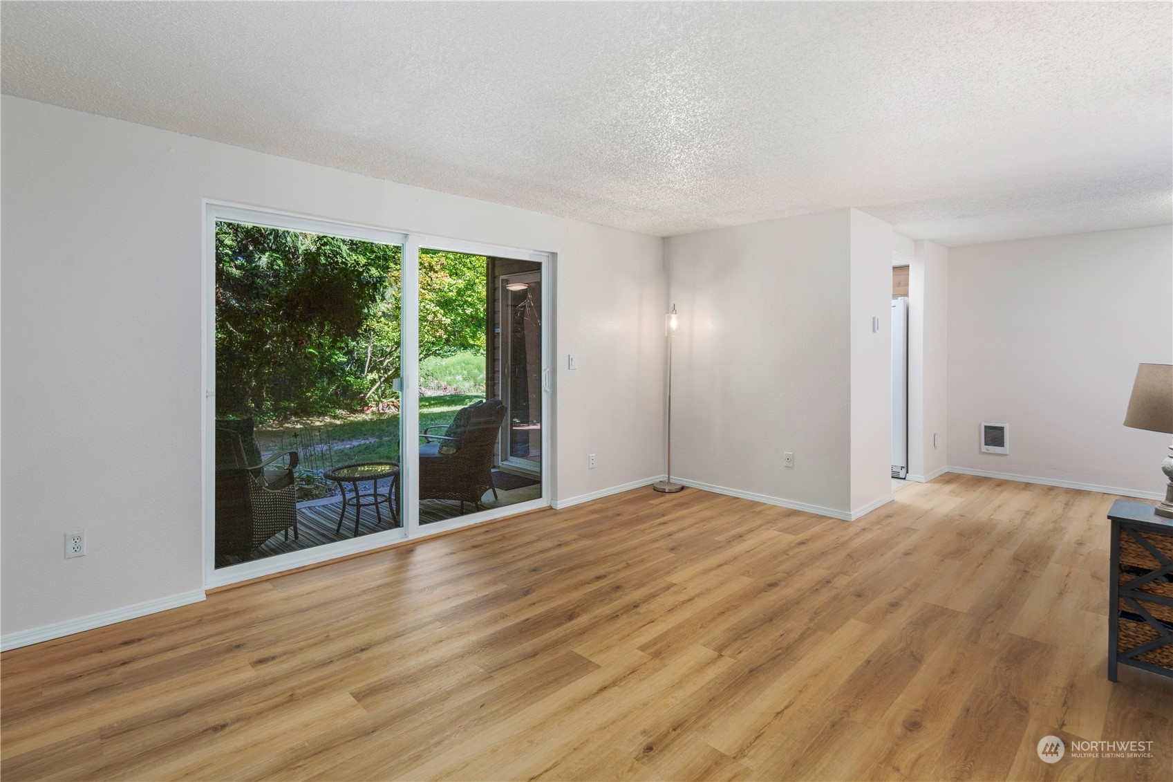 17522 151st Avenue Southeast, Unit 31 Renton, WA 98058 - Photo 10 of 37 a view of an empty room with wooden floor and a window