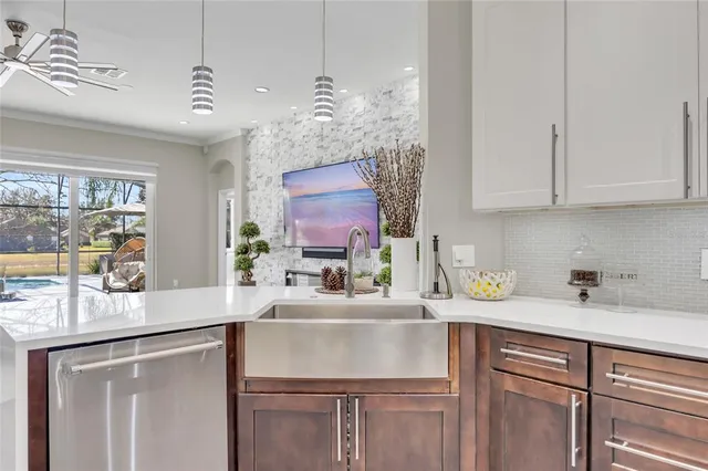 a kitchen with cabinets appliances and a window