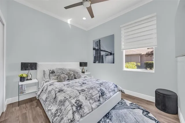 a bedroom with a bed and wooden floor