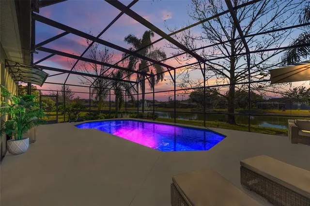 a view of swimming pool with red chairs