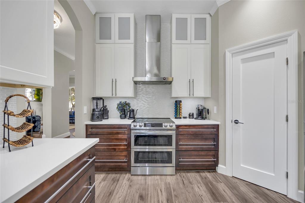 10600 Oakview Pointe Terrace Gotha, FL 34734 - Photo 10 of 44 a kitchen with kitchen island white cabinets and stainless steel appliances
