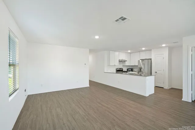 a view of kitchen with wooden floor and window