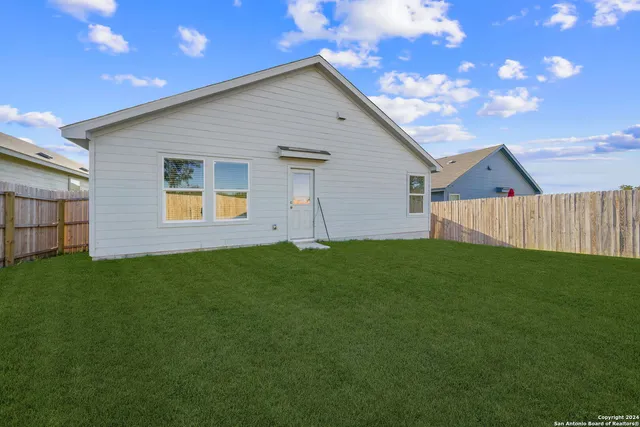 a view of a backyard with a garden and yard