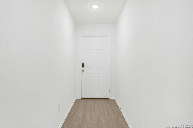 a view of a room with wooden floor