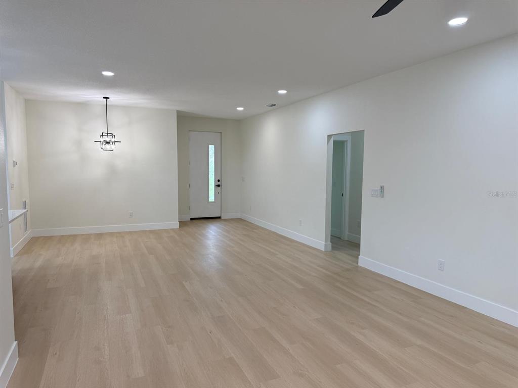 126 Canby Circle Spring Hill, FL 34606 - Photo 23 of 45 an empty room with wooden floor and windows