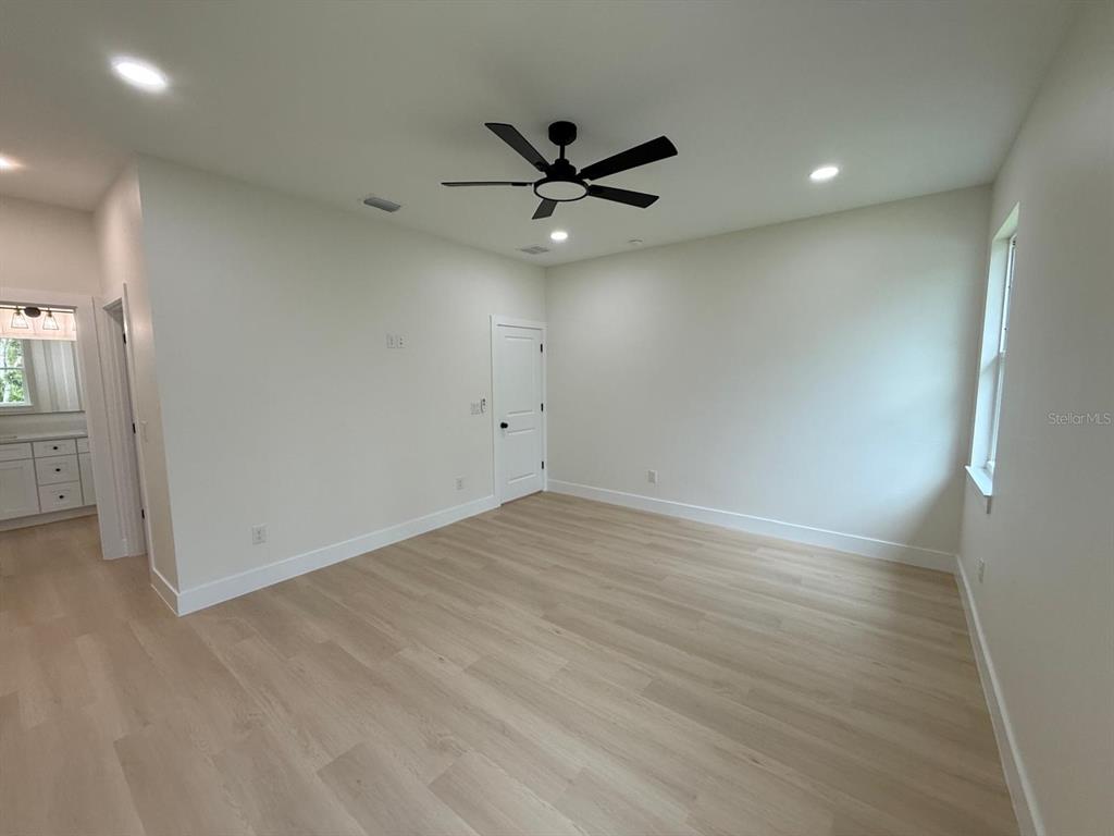 126 Canby Circle Spring Hill, FL 34606 - Photo 25 of 45 an empty room with a ceiling fan and window
