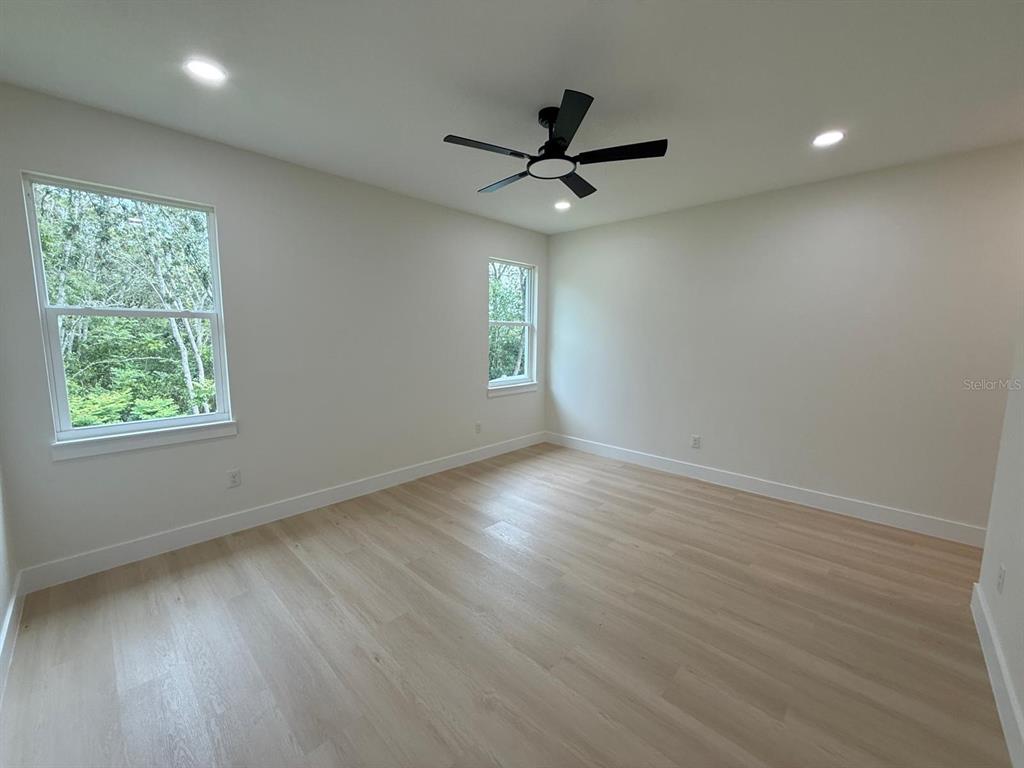 126 Canby Circle Spring Hill, FL 34606 - Photo 27 of 45 a view of empty room with wooden floor and fan
