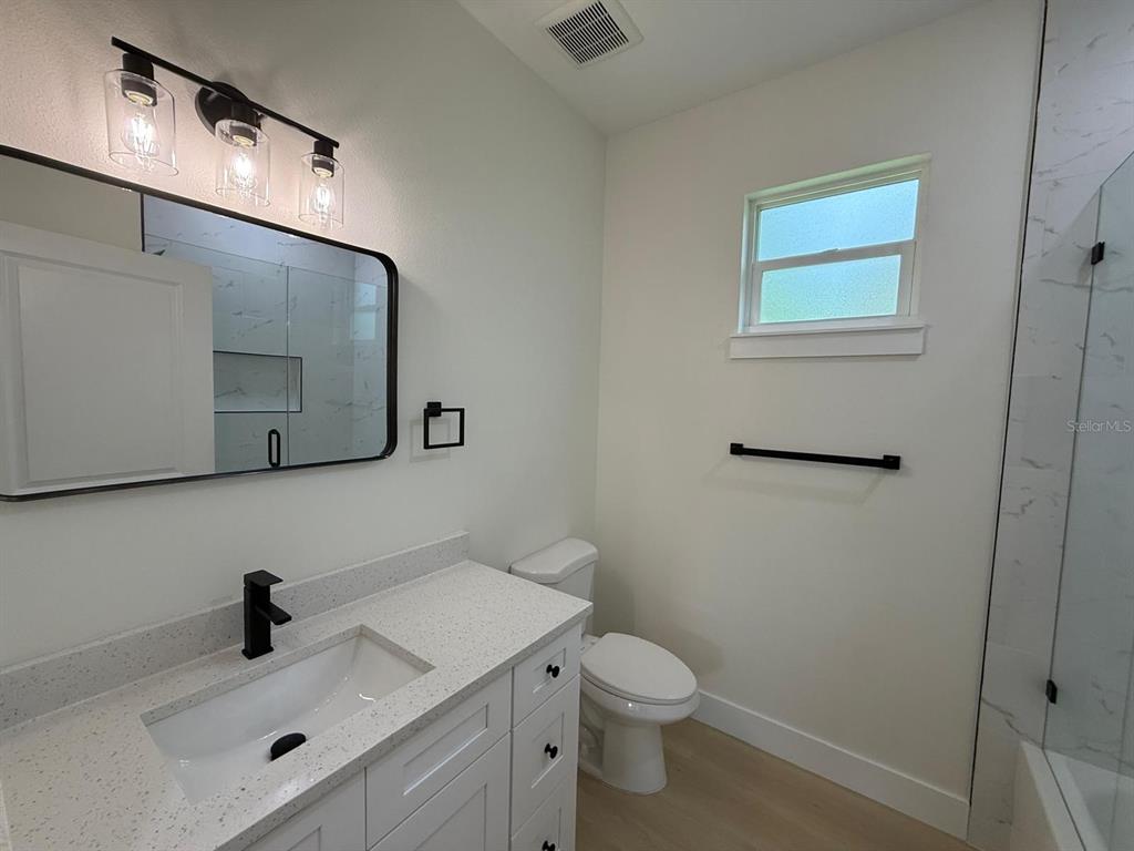 126 Canby Circle Spring Hill, FL 34606 - Photo 41 of 45 a bathroom with a toilet sink and mirror