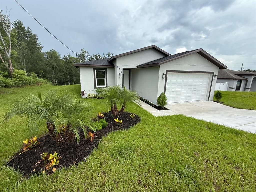126 Canby Circle Spring Hill, FL 34606 - Photo 7 of 45 a house view with a garden space