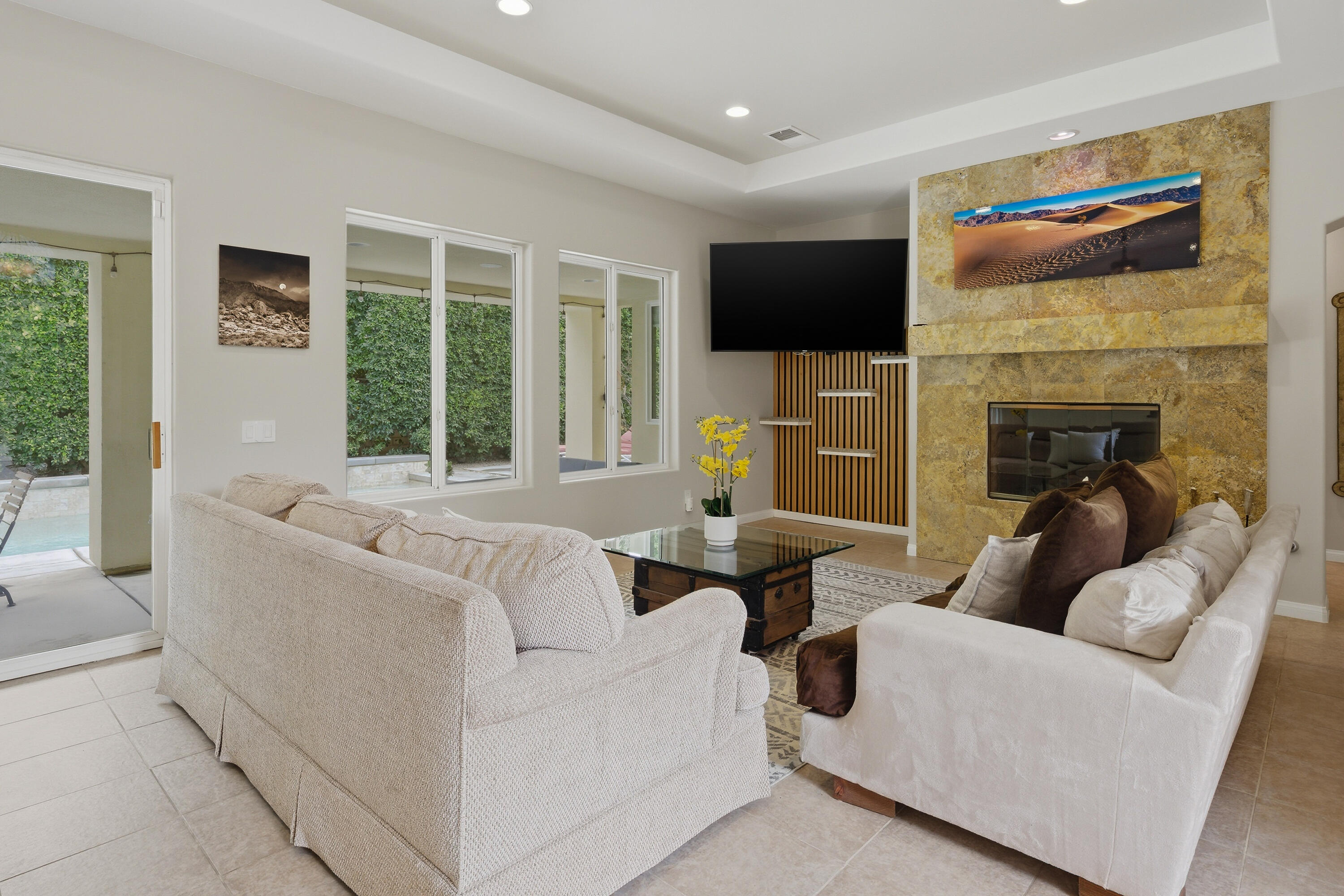 79120 Shadow Trail La Quinta, CA 92253 - Photo 20 of 60 a living room with furniture a flat screen tv and a fireplace