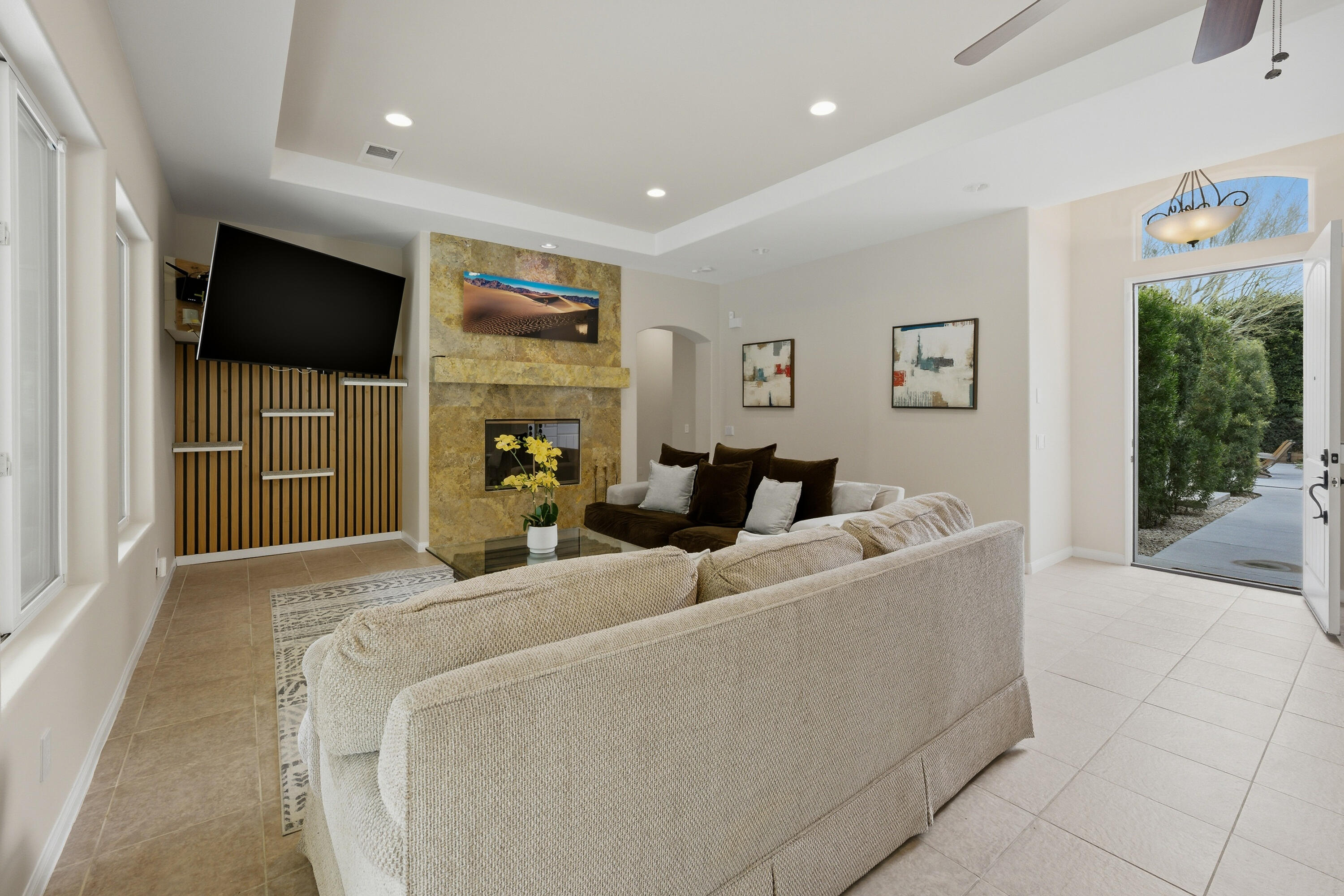 79120 Shadow Trail La Quinta, CA 92253 - Photo 23 of 60 a living room with furniture a flat screen tv and a floor to ceiling window