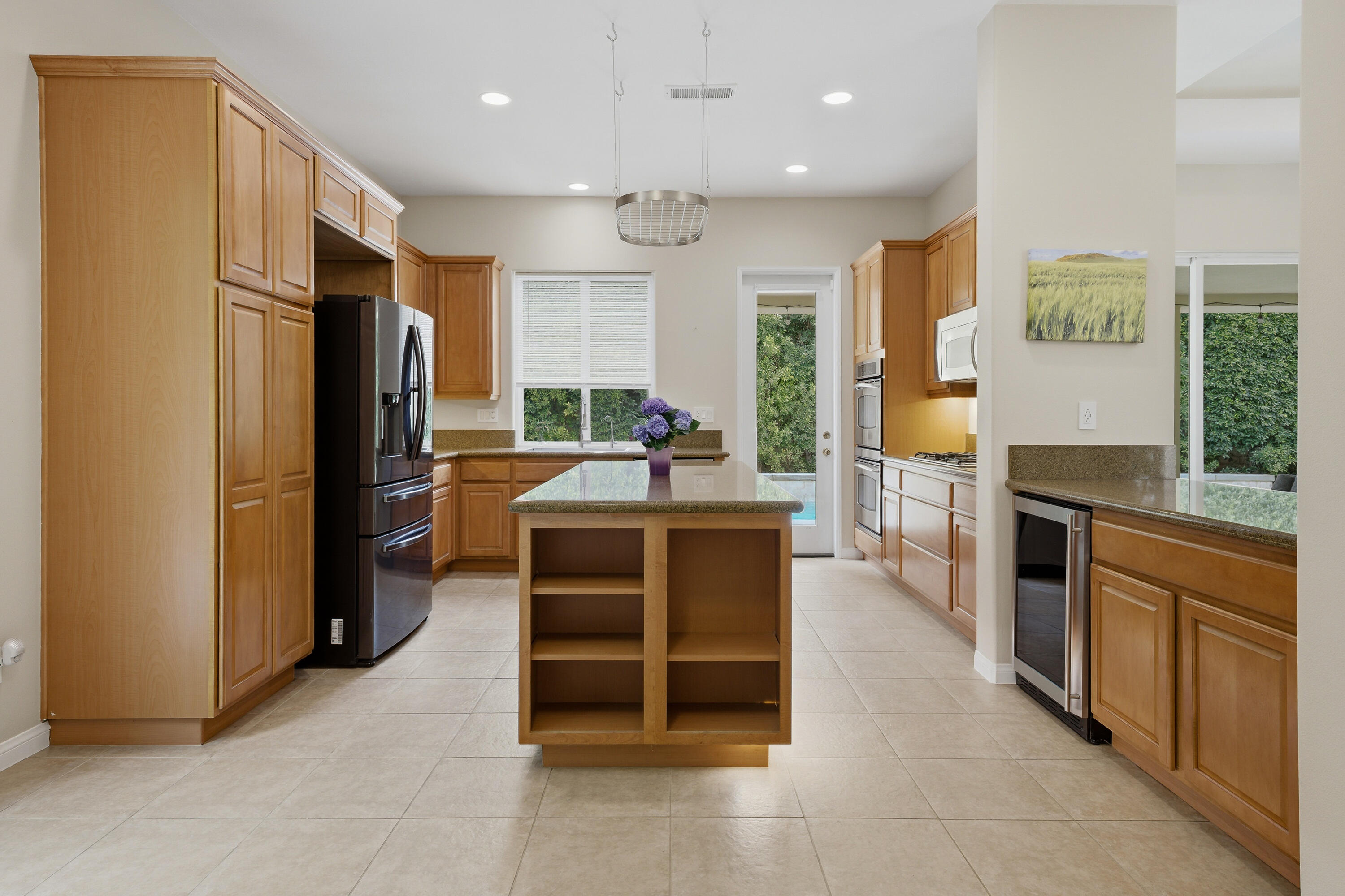 79120 Shadow Trail La Quinta, CA 92253 - Photo 26 of 60 a kitchen with stainless steel appliances kitchen island granite countertop a refrigerator and a stove top oven