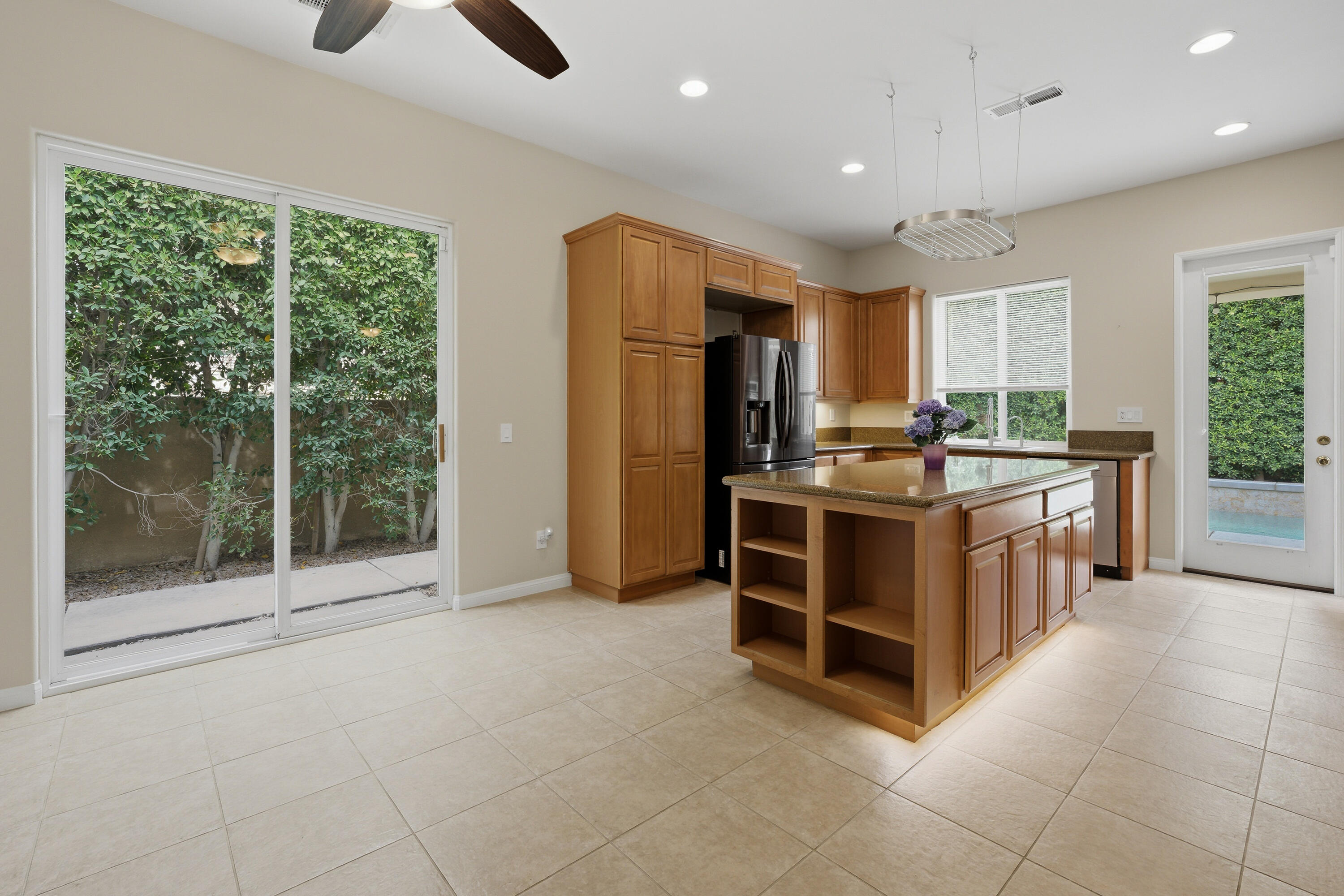 79120 Shadow Trail La Quinta, CA 92253 - Photo 27 of 60 a kitchen with stainless steel appliances a stove top oven a sink a counter top space and cabinets