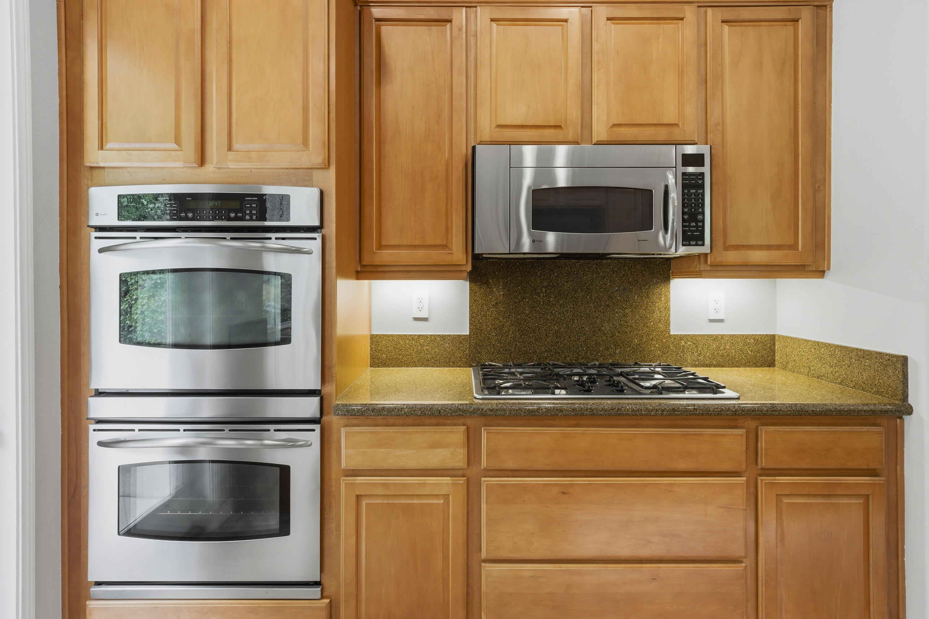79120 Shadow Trail La Quinta, CA 92253 - Photo 29 of 60 a kitchen with granite countertop white cabinets stainless steel appliances and a sink