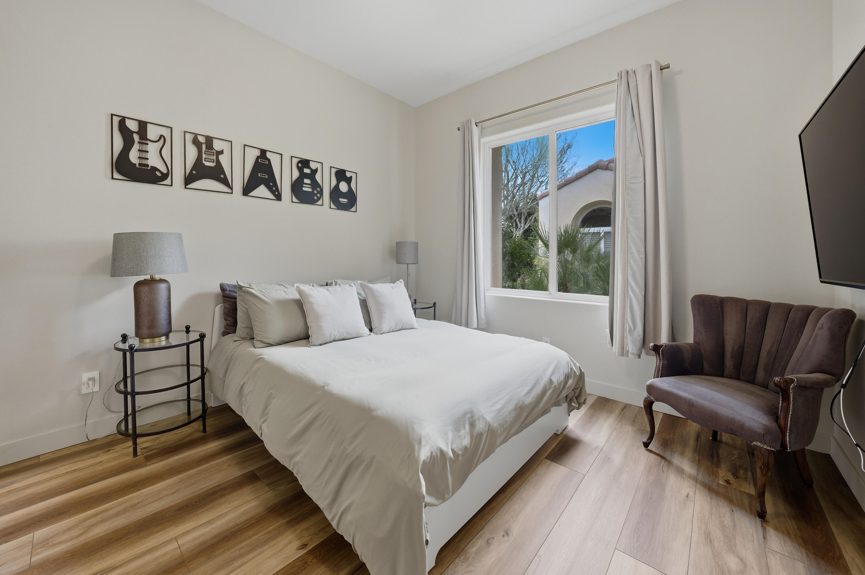 79120 Shadow Trail La Quinta, CA 92253 - Photo 40 of 60 a bedroom with a bed and a chair