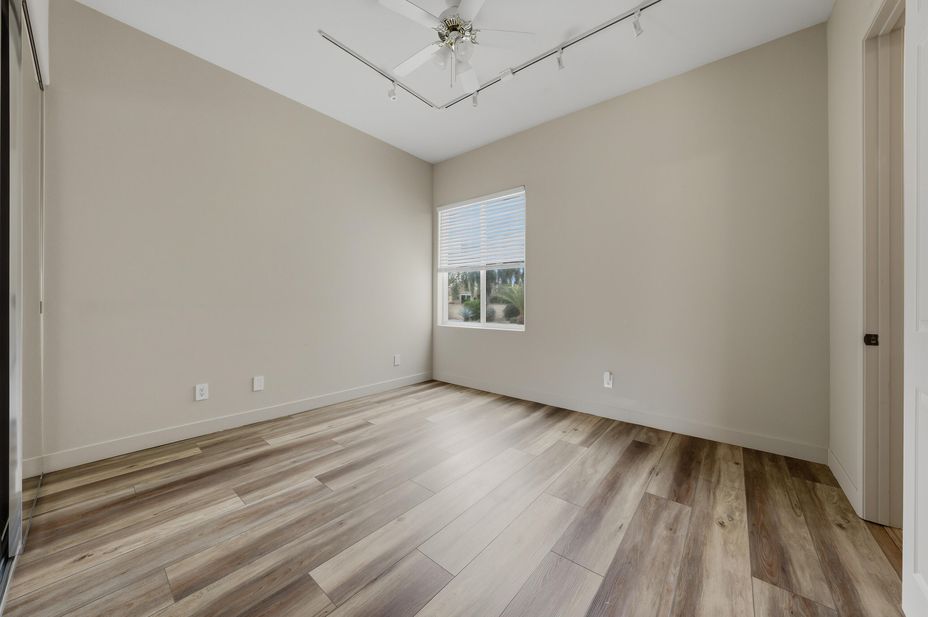79120 Shadow Trail La Quinta, CA 92253 - Photo 44 of 60 a view of an empty room with wooden floor and a window