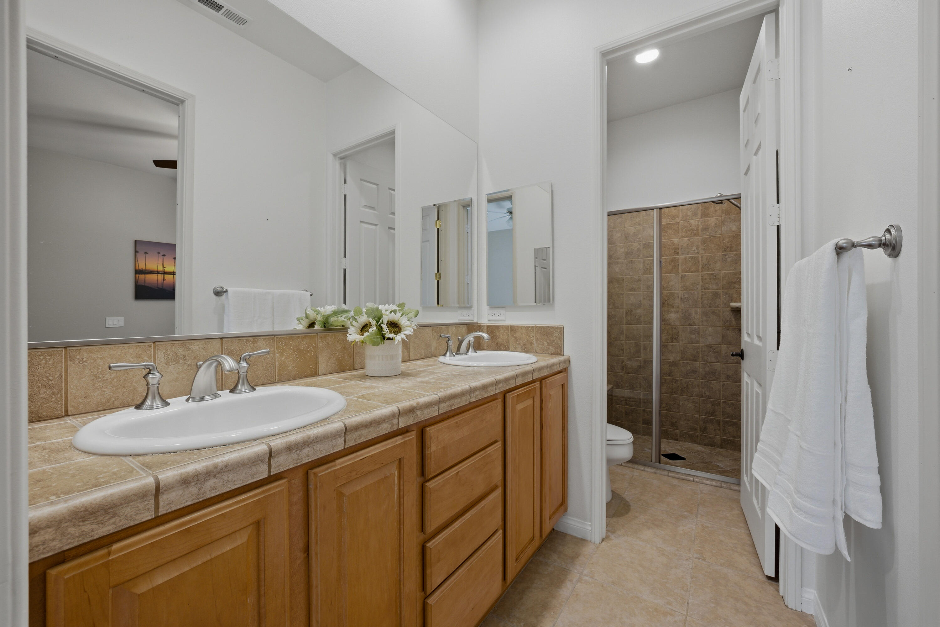 79120 Shadow Trail La Quinta, CA 92253 - Photo 45 of 60 a bathroom with a granite countertop sink and a mirror