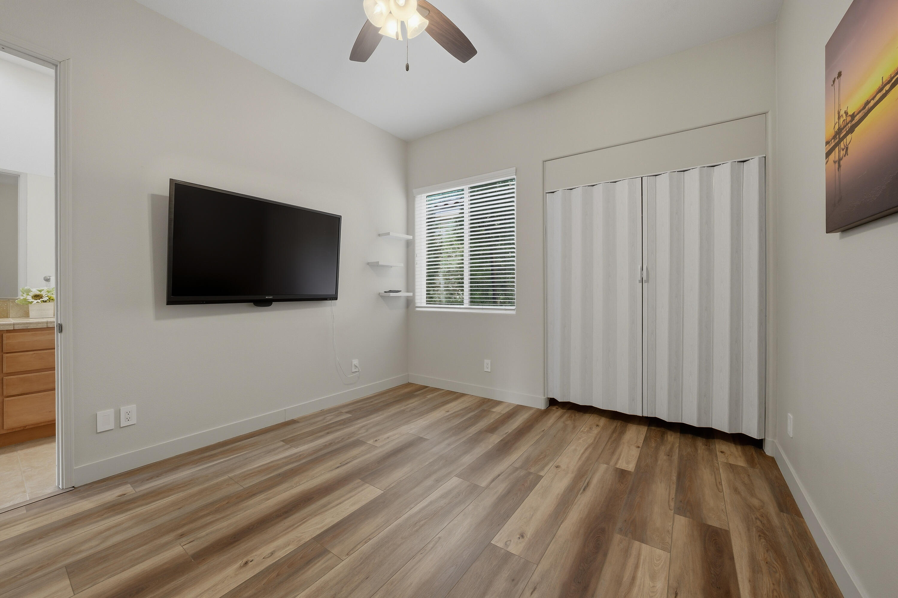 79120 Shadow Trail La Quinta, CA 92253 - Photo 46 of 60 a view of a livingroom with wooden floor and a flat screen tv