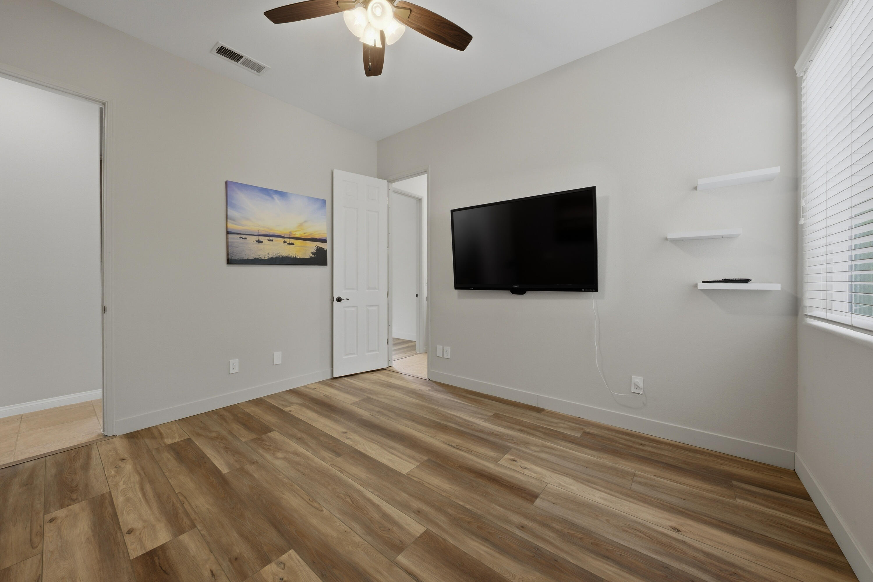 79120 Shadow Trail La Quinta, CA 92253 - Photo 47 of 60 an empty room with windows and ceiling fan