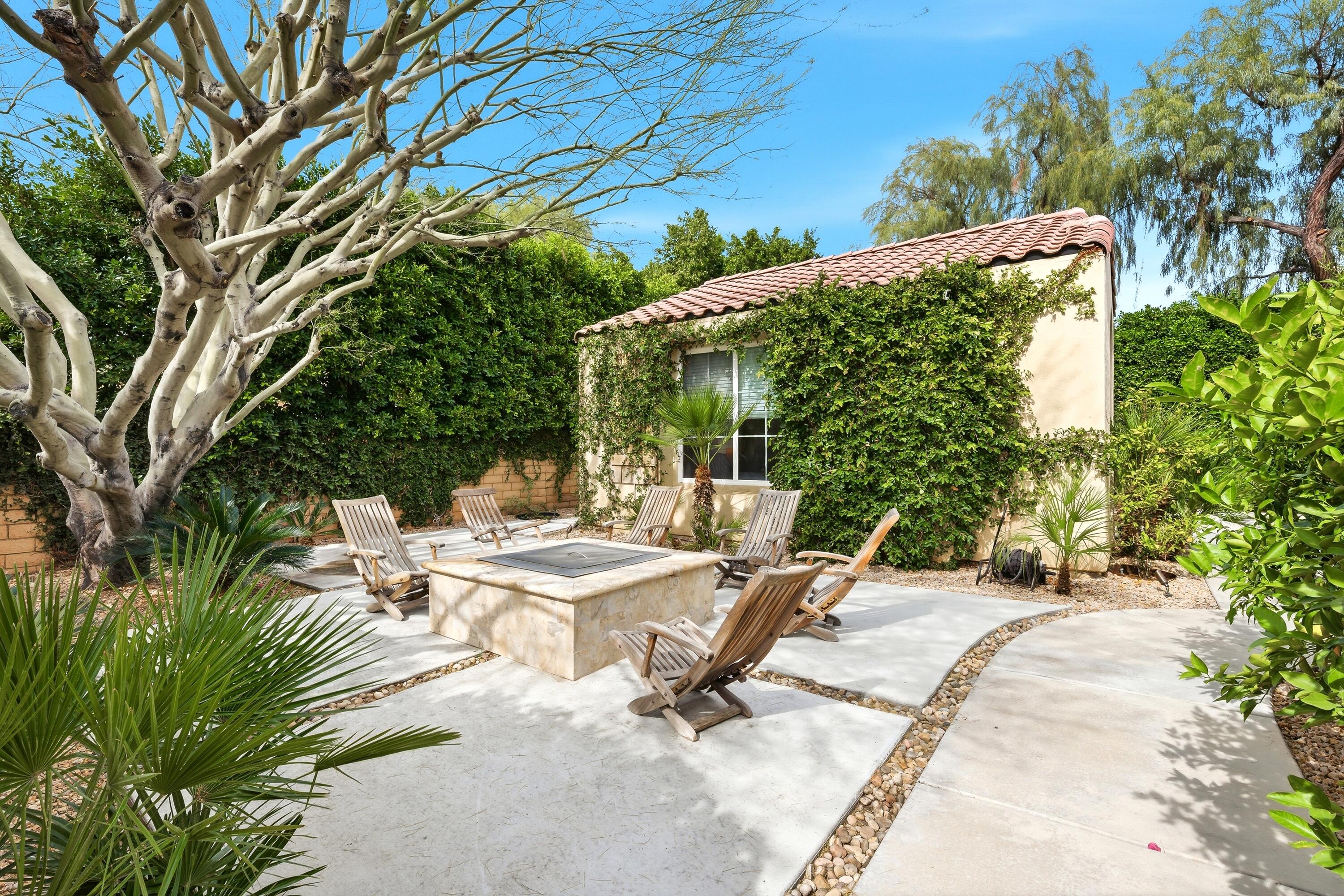 79120 Shadow Trail La Quinta, CA 92253 - Photo 5 of 60 a view of backyard with a table and chairs under an umbrella