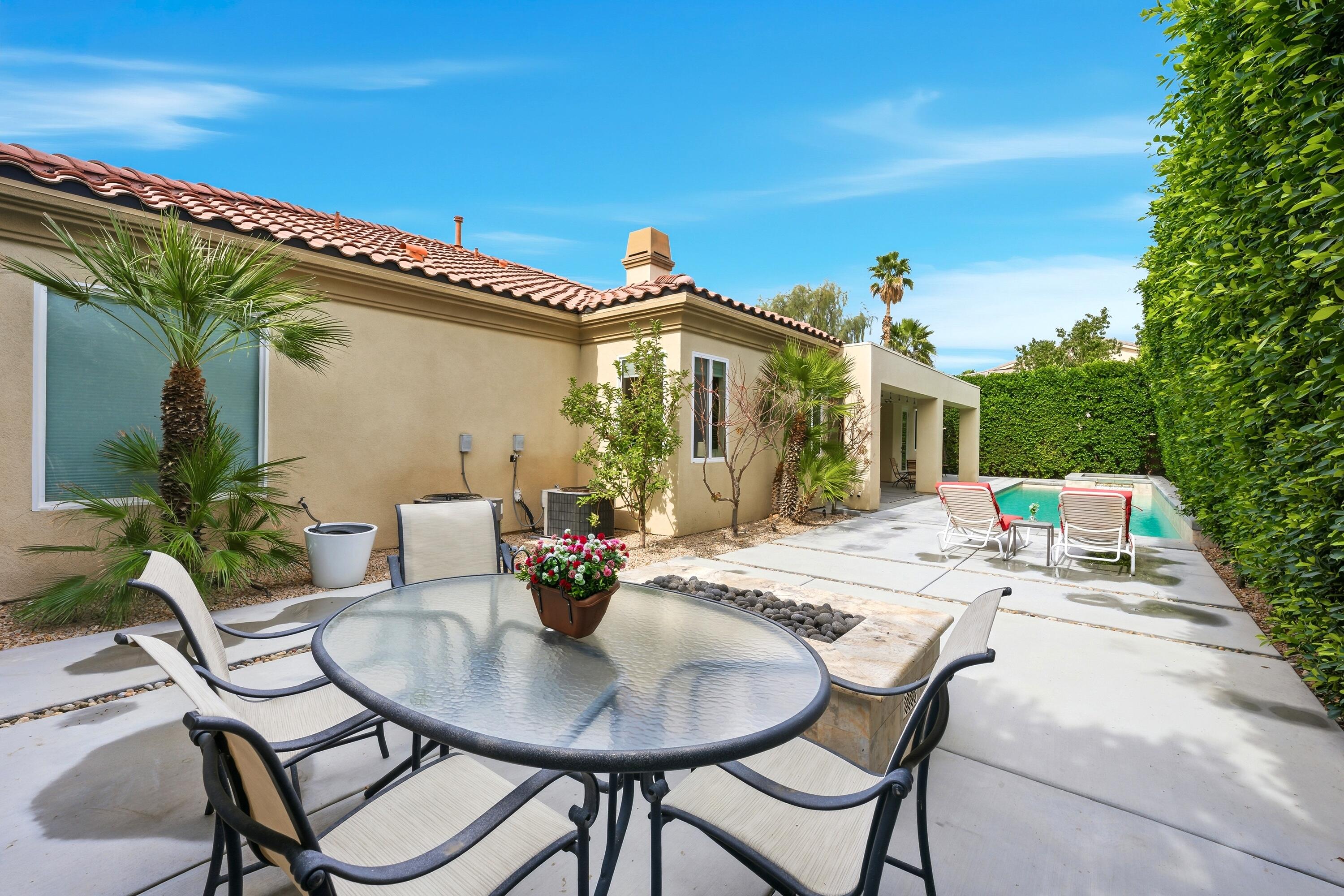 79120 Shadow Trail La Quinta, CA 92253 - Photo 59 of 60 a view of a patio with table and chairs and potted plants