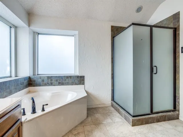 a bathroom with a bathtub and a shower