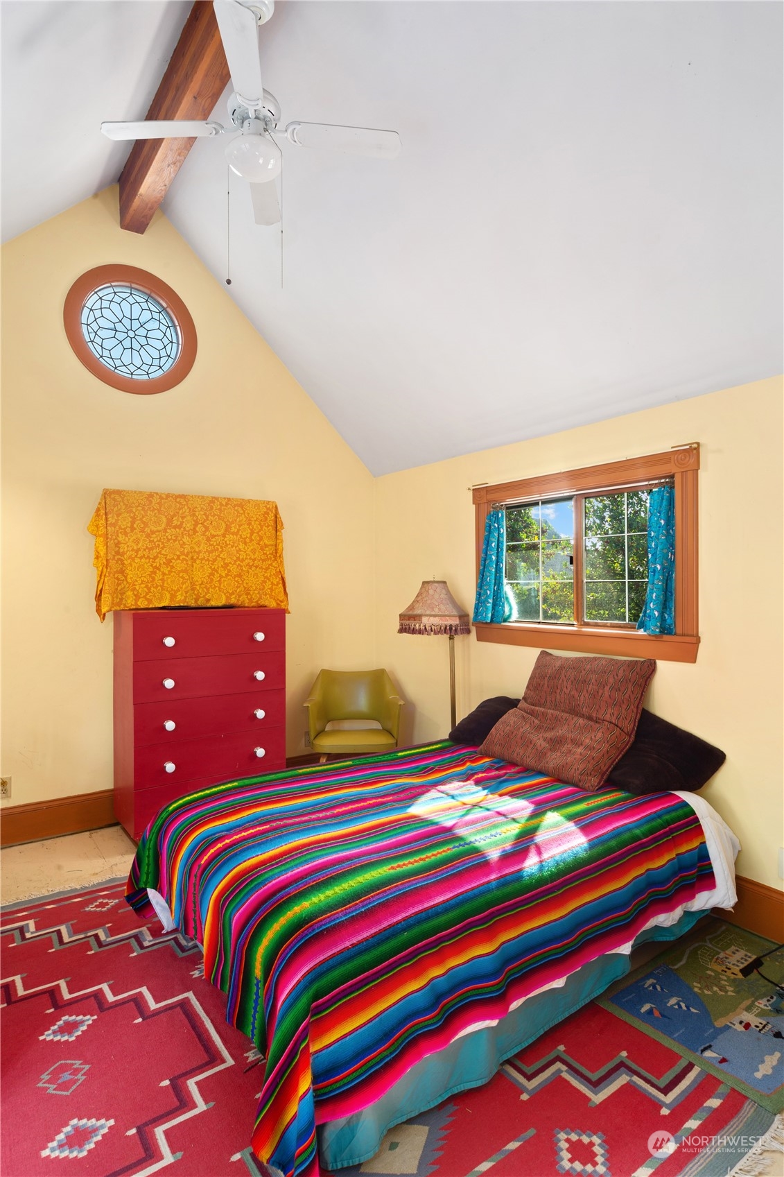 1441 Clay Street Port Townsend, WA 98368 - Photo 14 of 26 a bedroom with a bed and a lamp next to a window