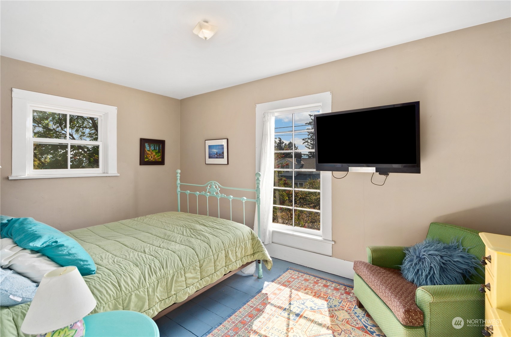 1441 Clay Street Port Townsend, WA 98368 - Photo 20 of 26 a bedroom with a bed a flat screen tv and a window