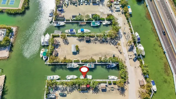 an aerial view of residential houses with outdoor space and lake view