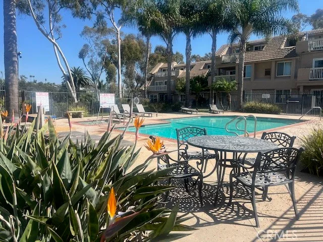 a view of a chairs and table in backyard