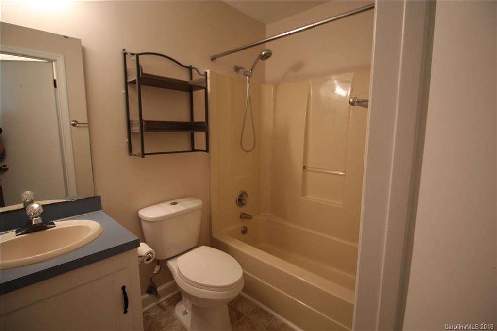 1715 Carmel Church Road, Unit 2 Monroe, NC 28112 - Photo 12 of 19 a bathroom with a shower a toilet and sink