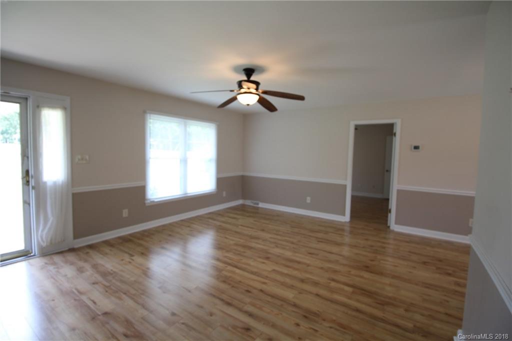 1715 Carmel Church Road, Unit 2 Monroe, NC 28112 - Photo 16 of 19 a view of empty room with wooden floor and fan