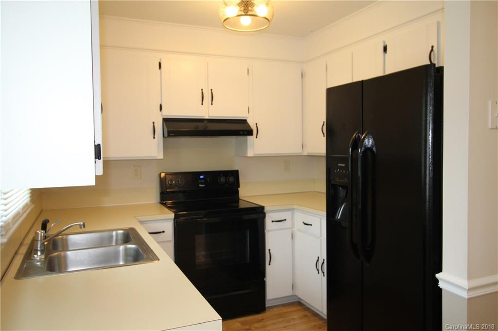 1715 Carmel Church Road, Unit 2 Monroe, NC 28112 - Photo 4 of 19 a kitchen with a refrigerator and a sink