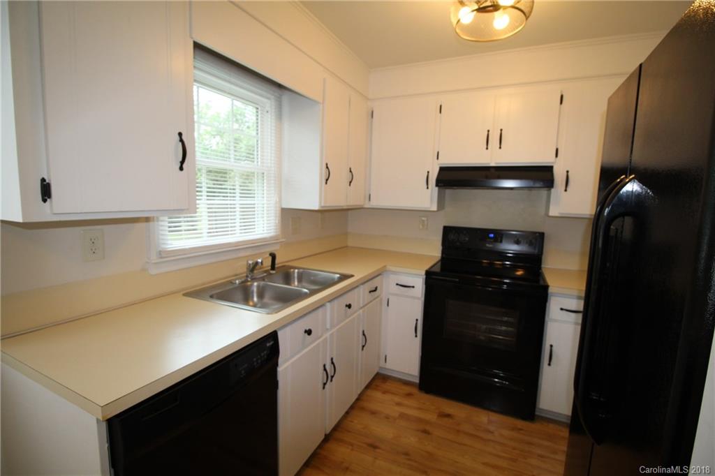 1715 Carmel Church Road, Unit 2 Monroe, NC 28112 - Photo 6 of 19 a kitchen with a sink a stove and a refrigerator