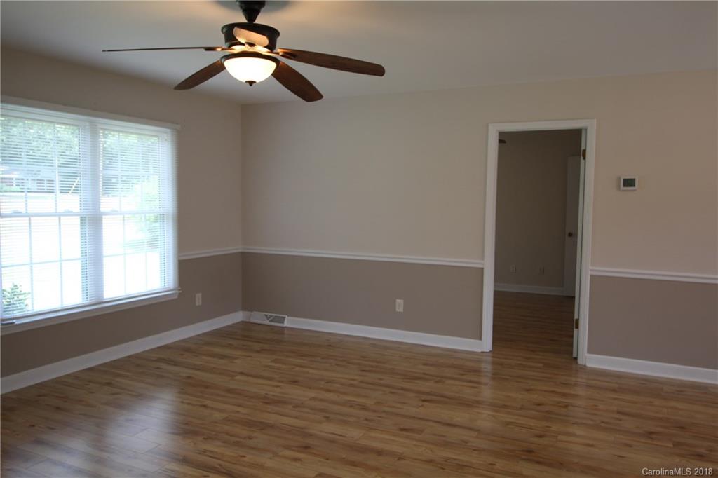 1715 Carmel Church Road, Unit 2 Monroe, NC 28112 - Photo 7 of 19 wooden floor in an empty room with a window