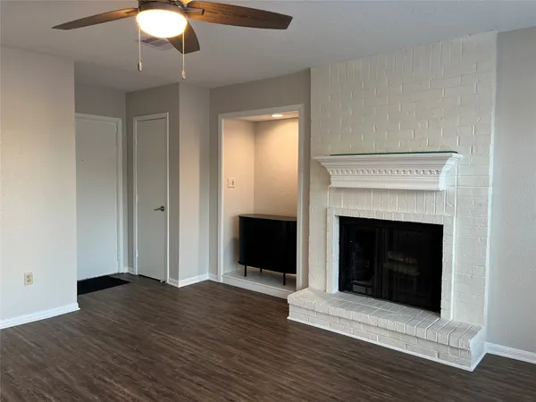 a kitchen with granite countertop a sink and a refrigerator