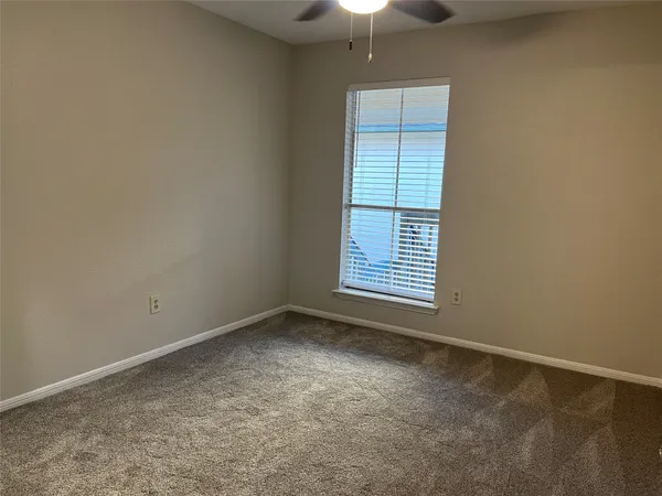 a bathroom with a granite countertop sink and a toilet