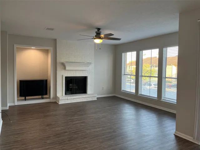 a kitchen with a sink cabinets and a wooden floor
