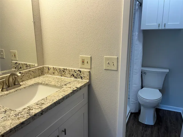 a bathroom with a toilet and a shower