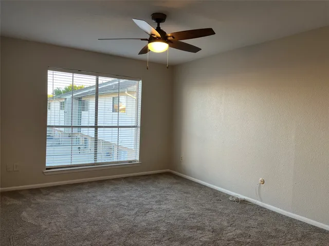 a bathroom with a granite countertop sink and a toilet