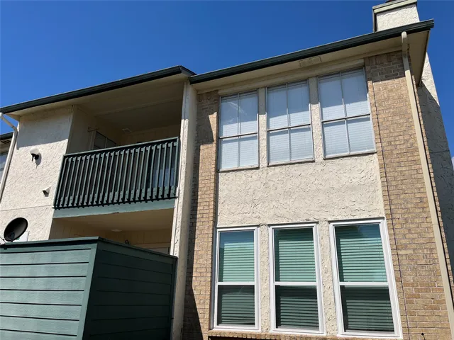 a view of a hallway with wooden floor and a cabinet