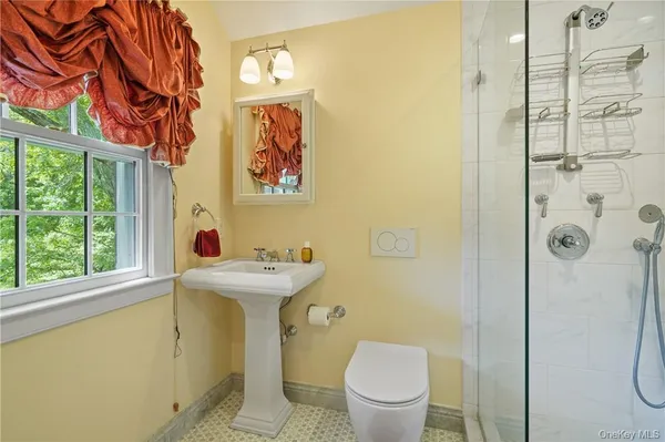 a bathroom with a sink toilet and shower