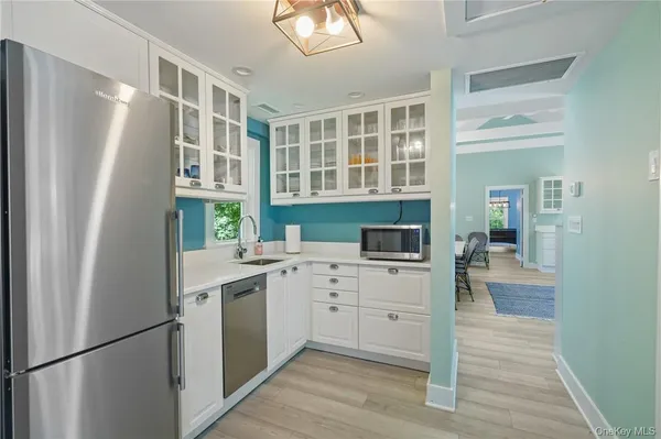 a kitchen with a refrigerator sink and cabinets